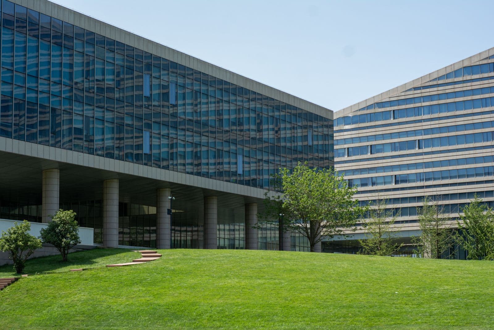 Maintained lawn and landscaped grounds around an institutional building; illustrative stock photograph